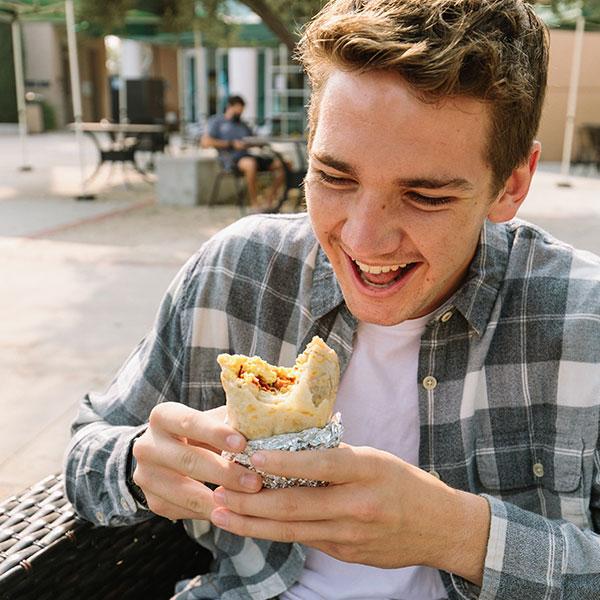 Student eating the famous CUI breakfast burrito